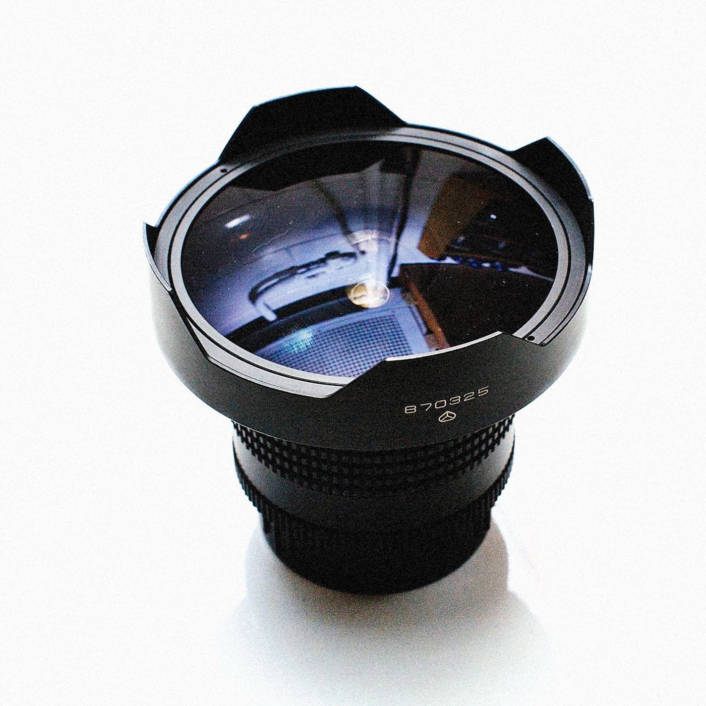 Extreme close-up of a cinema lens glass reflecting studio lights