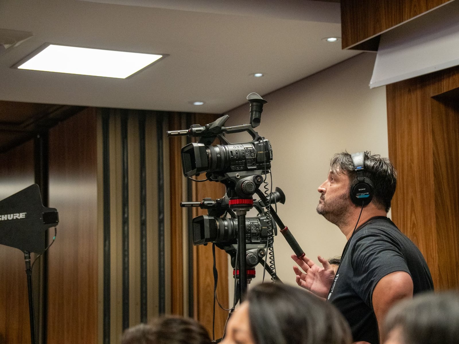 Videographer filming a business conference in Nagoya with dynamic movement