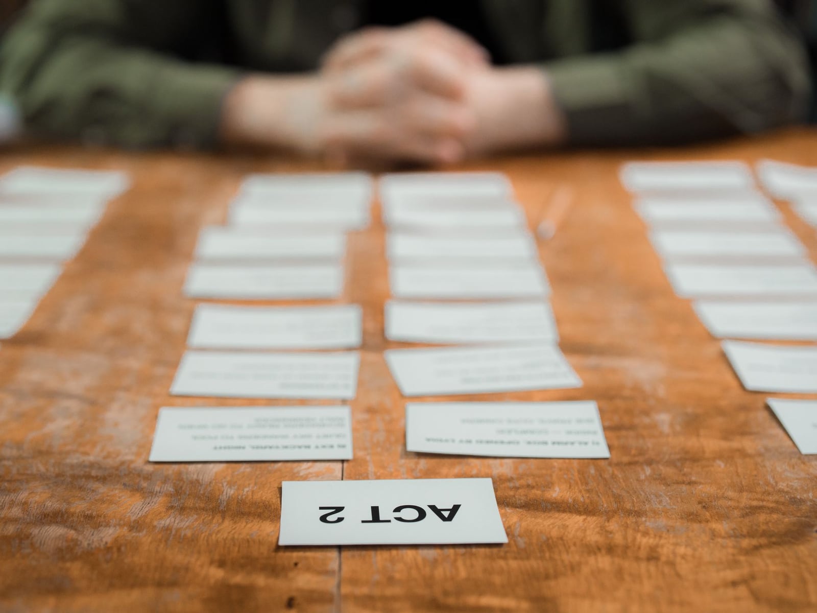 Detail of a video script and storyboard spread across a wooden desk